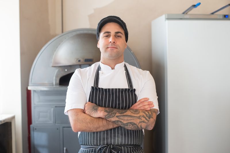 Friendly front-of-house team member at Dewey's pizza